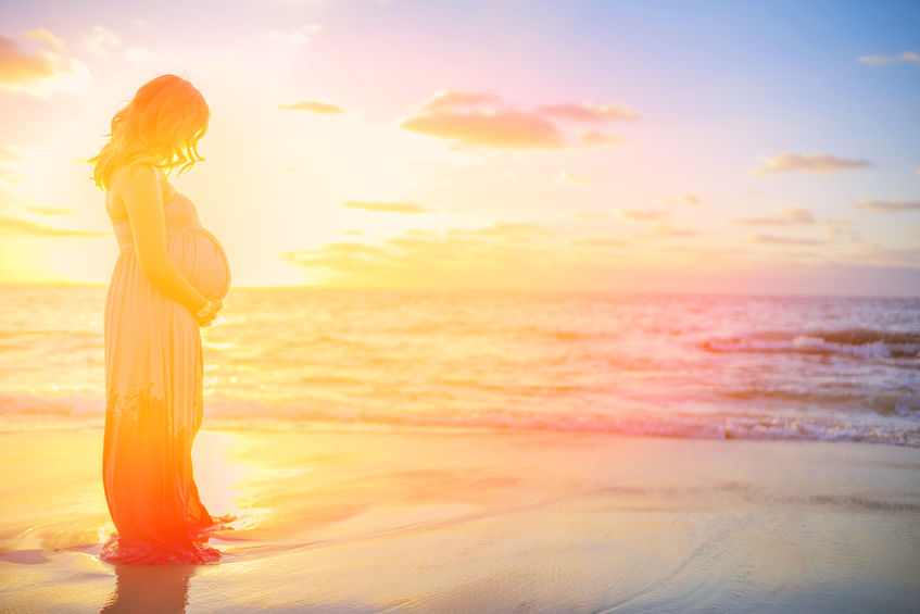 Sing O Barren - Bob Sawvelle - Pregnant woman in the sunset on the beach. Beautiful sunset.